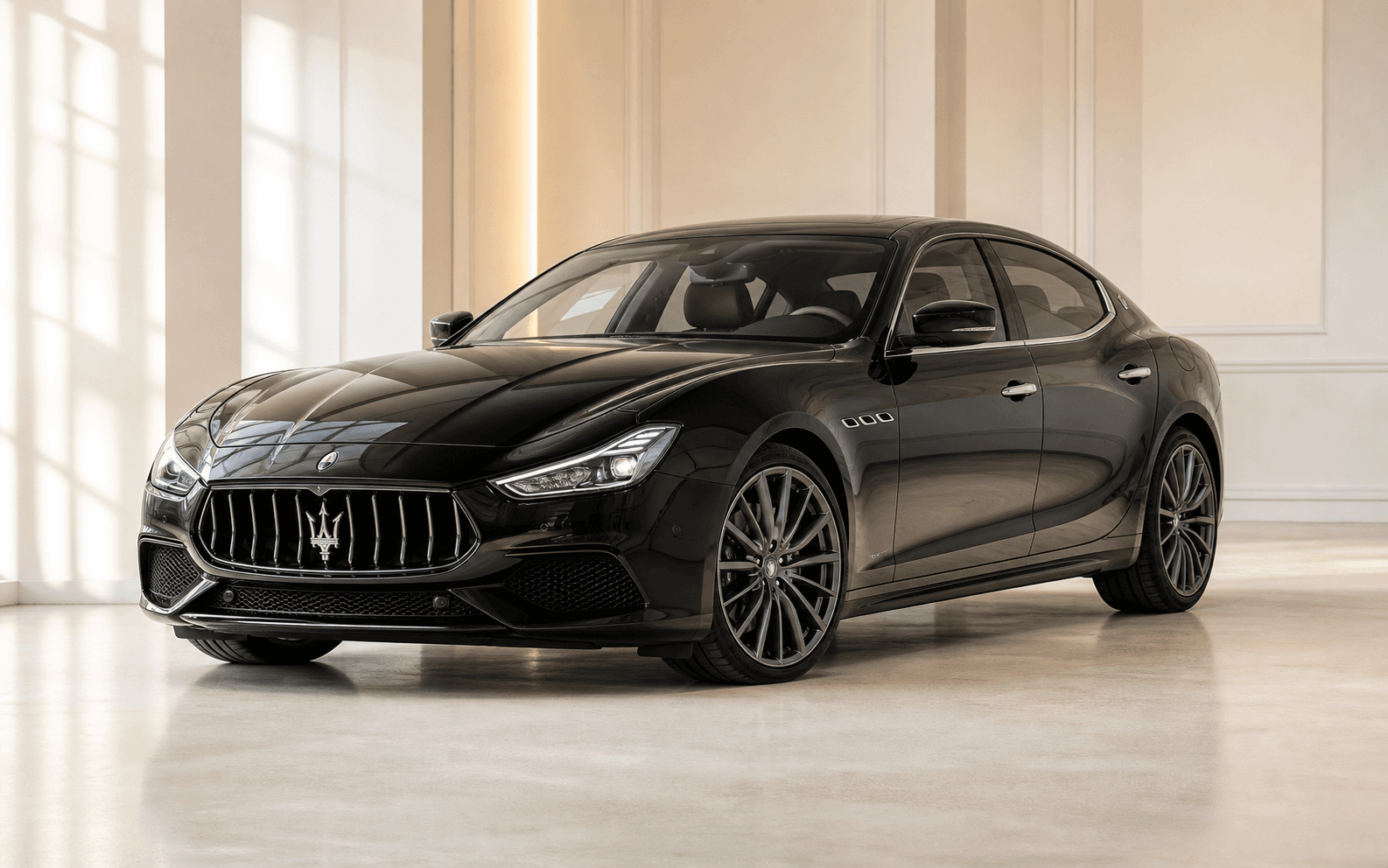 Black Maserati Ghibli in a bright premium showroom